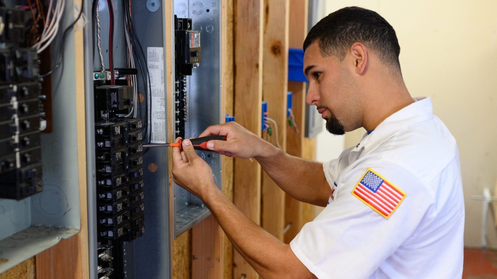 Electrician repairing a breaker on a home's electrical panel
