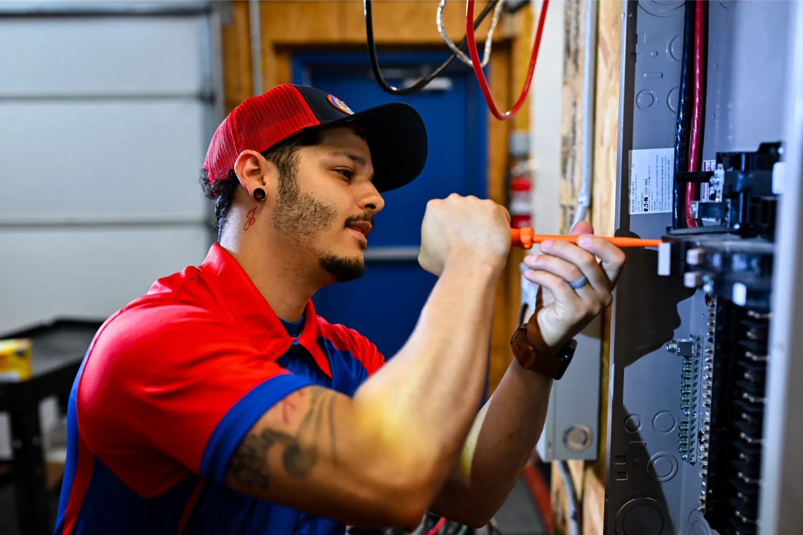 Technician installing new circuits in a home's electrical panel.